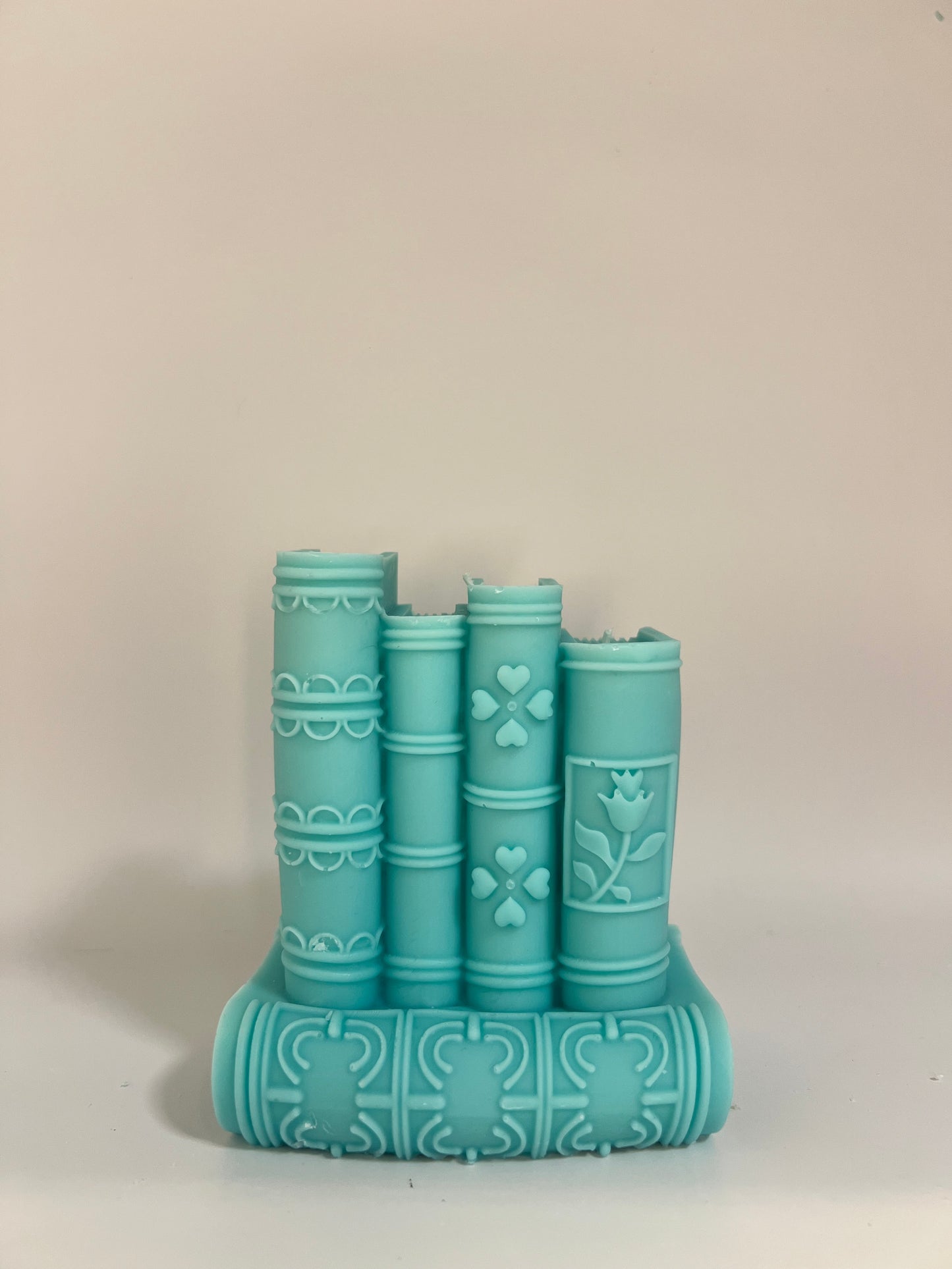 “Luxury soy wax candle trio with two book-shaped candles in beige and blue inspired by Baccarat Rouge 540, and one gray pillar candle with Millionaire Man scent – handmade sculptural candles for home decor and gifting