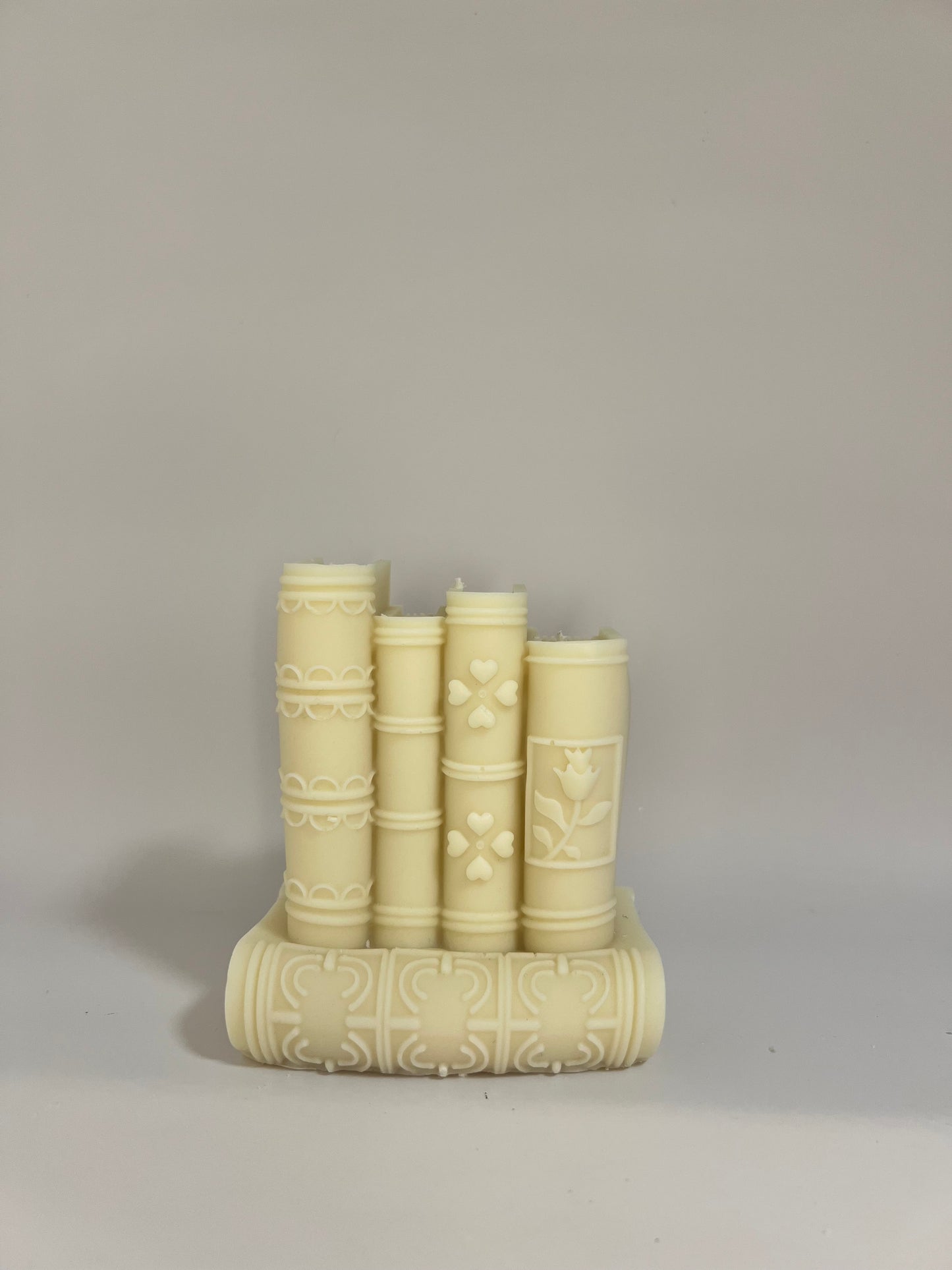 “Luxury soy wax candle trio with two book-shaped candles in beige and blue inspired by Baccarat Rouge 540, and one gray pillar candle with Millionaire Man scent – handmade sculptural candles for home decor and gifting