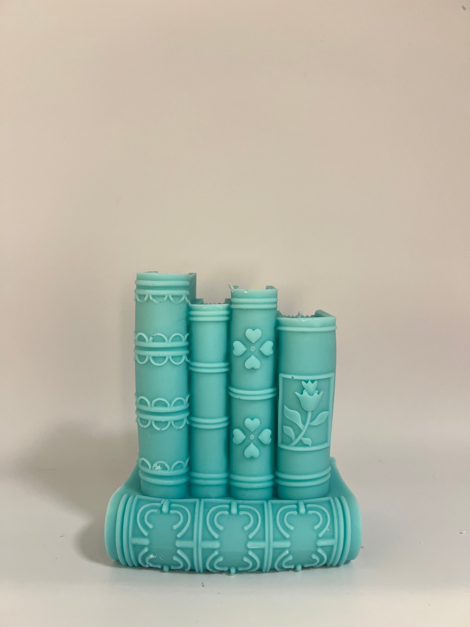 “Luxury soy wax candle trio with two book-shaped candles in beige and blue inspired by Baccarat Rouge 540, and one gray pillar candle with Millionaire Man scent – handmade sculptural candles for home decor and gifting