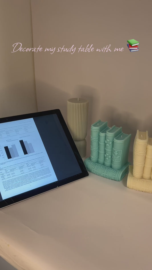 “Luxury soy wax candle trio with two book-shaped candles in beige and blue inspired by Baccarat Rouge 540, and one gray pillar candle with Millionaire Man scent – handmade sculptural candles for home decor and gifting